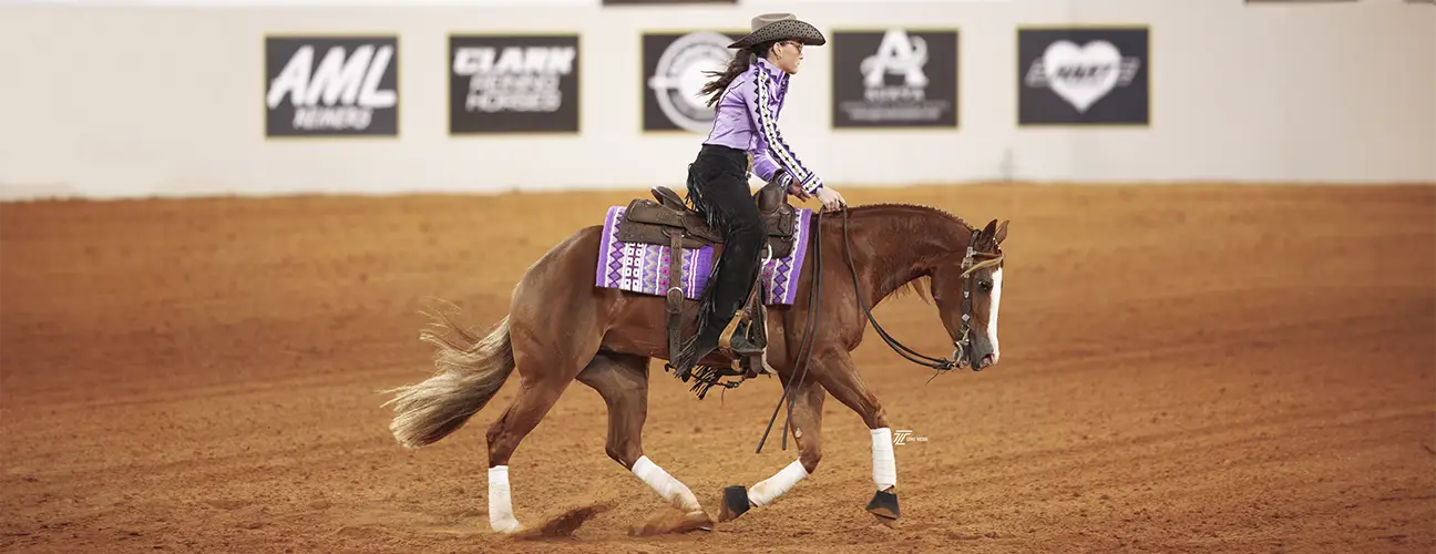 Peyton Derr, performing sliding stop on chestnut reining horse