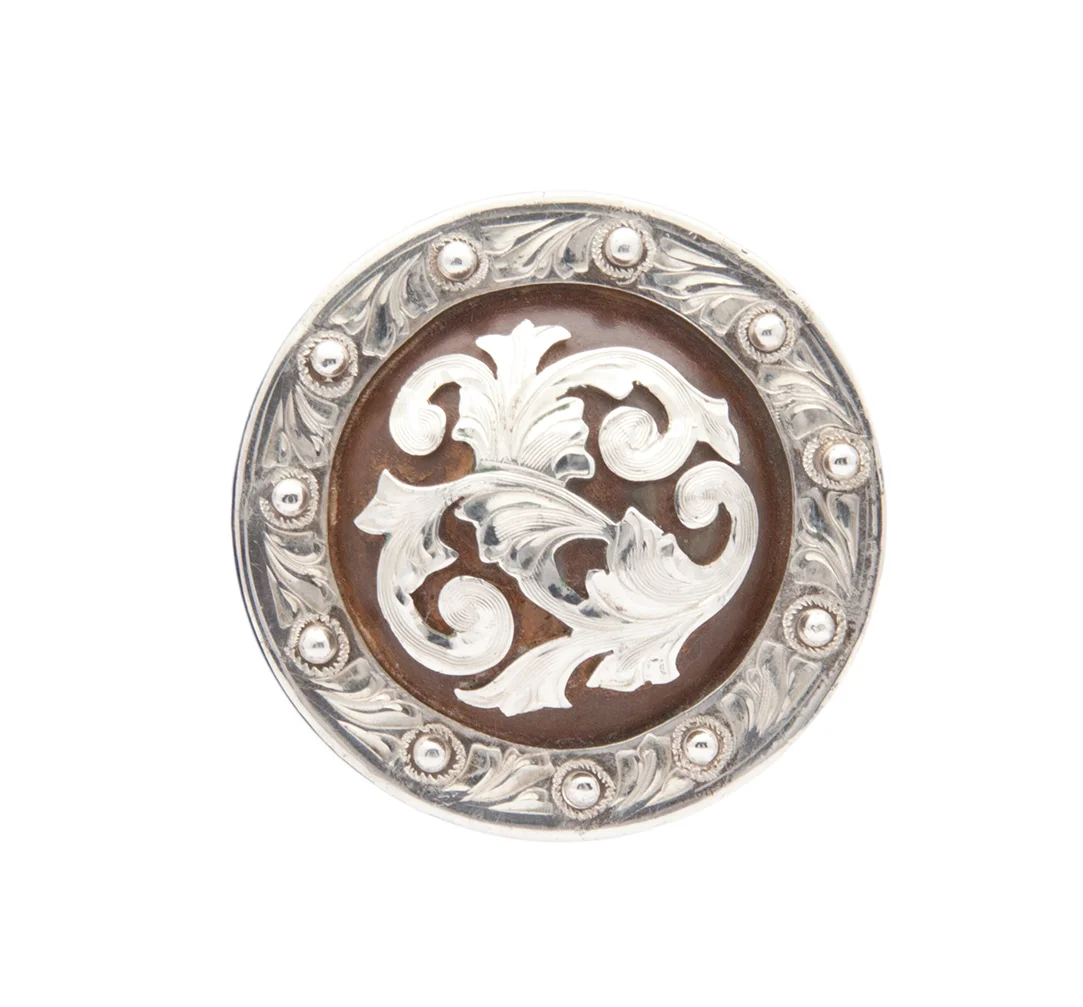 Bakersfield rust iron and silver concho crafted for custom western leatherwork.