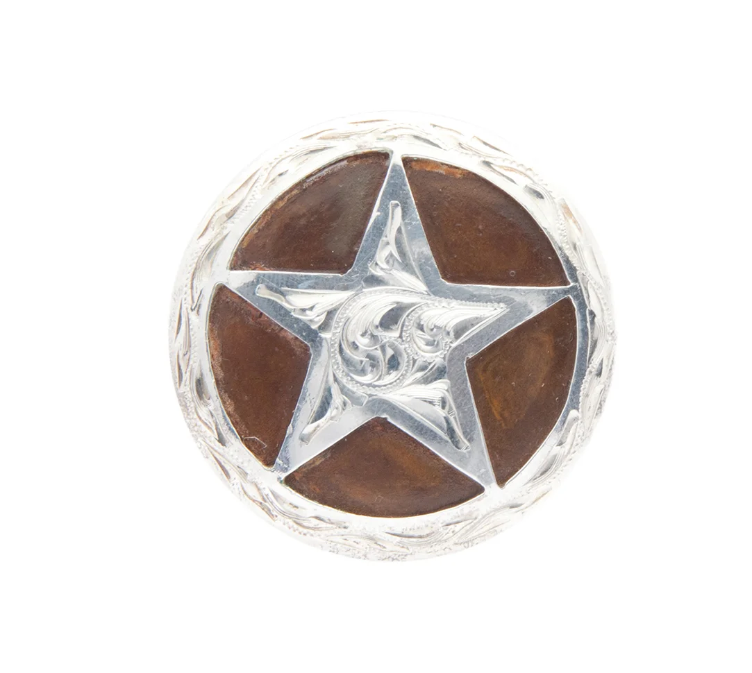 Brazos silver and rust iron concho handcrafted for premium western leather gear.