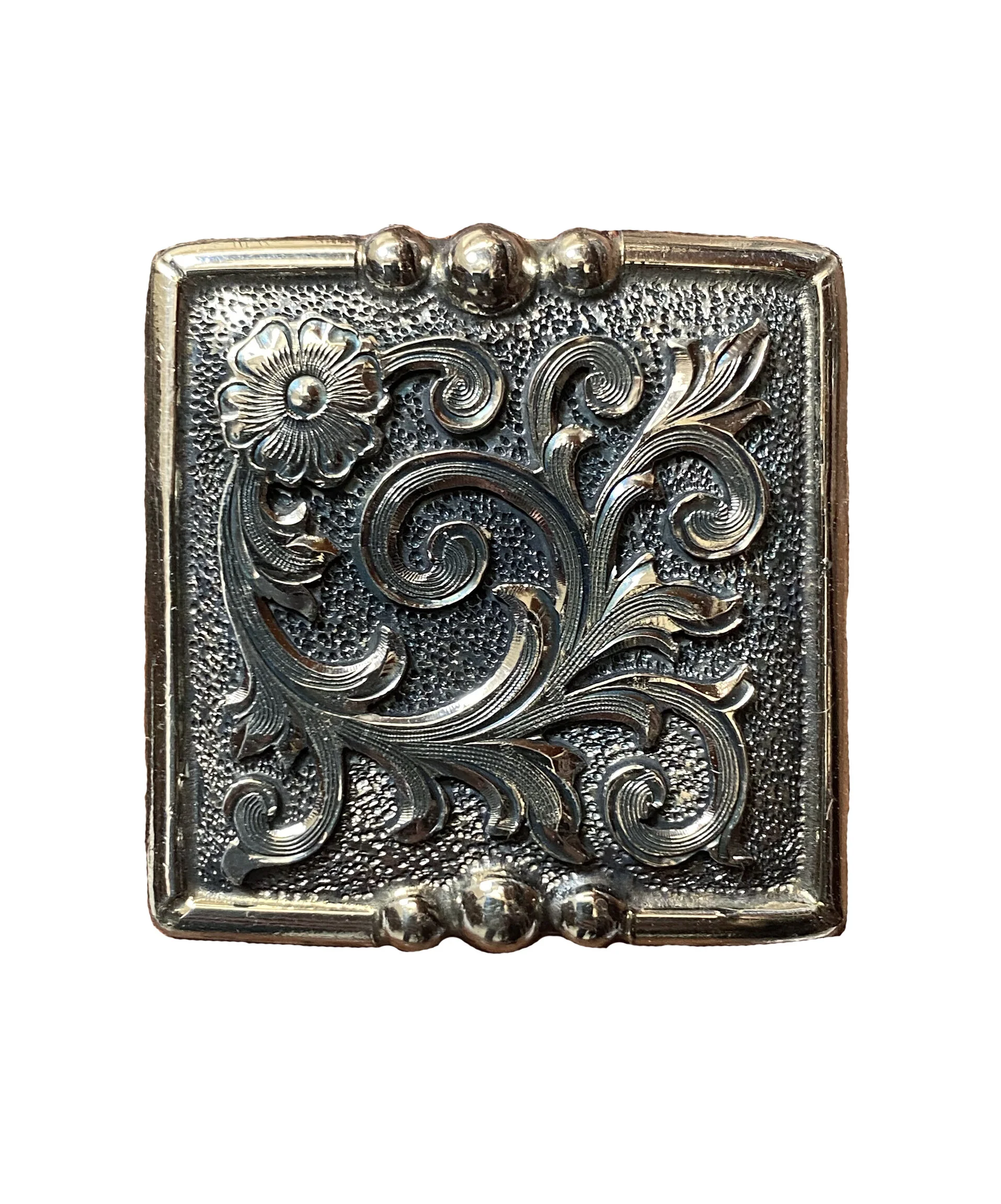 Decorative square nickel concho with floral center for western leather gear and saddles.