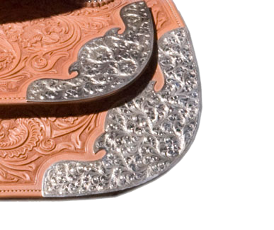 Flagstaff custom saddle rear skirt corners and housing plates for western saddles.