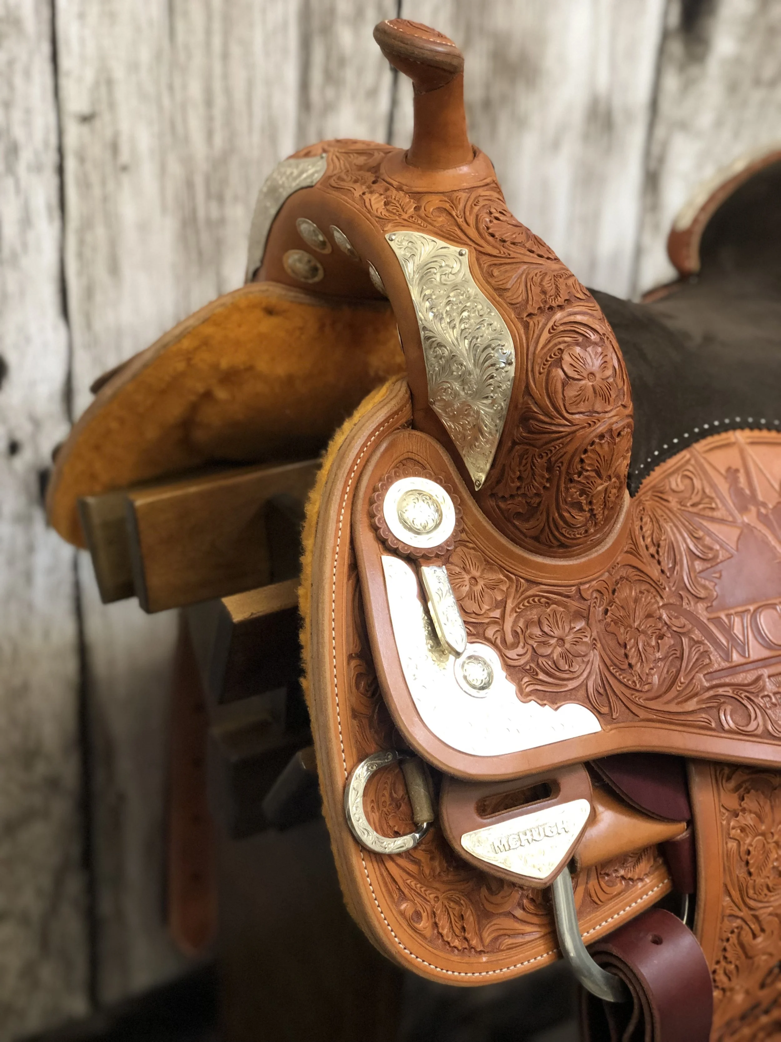 Front DH silver overlay saddle plates crafted for premium western saddle customization.