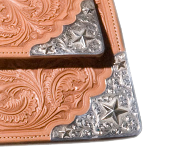 Liberty model rear skirt corner plates and housings for custom western saddles.