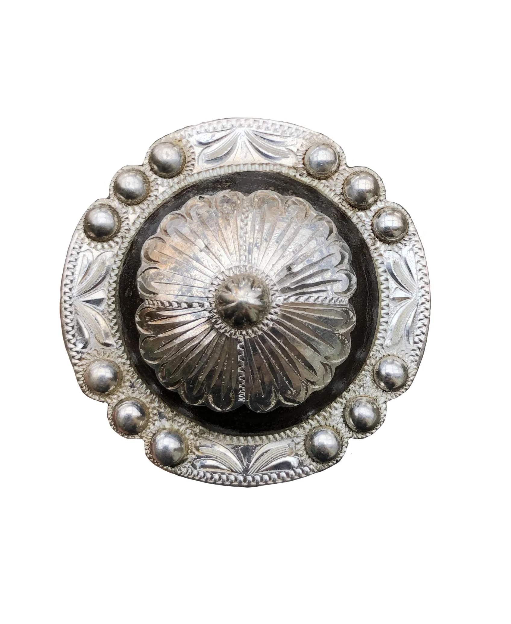 Rust iron and silver concho with floral center crafted for custom western saddles.