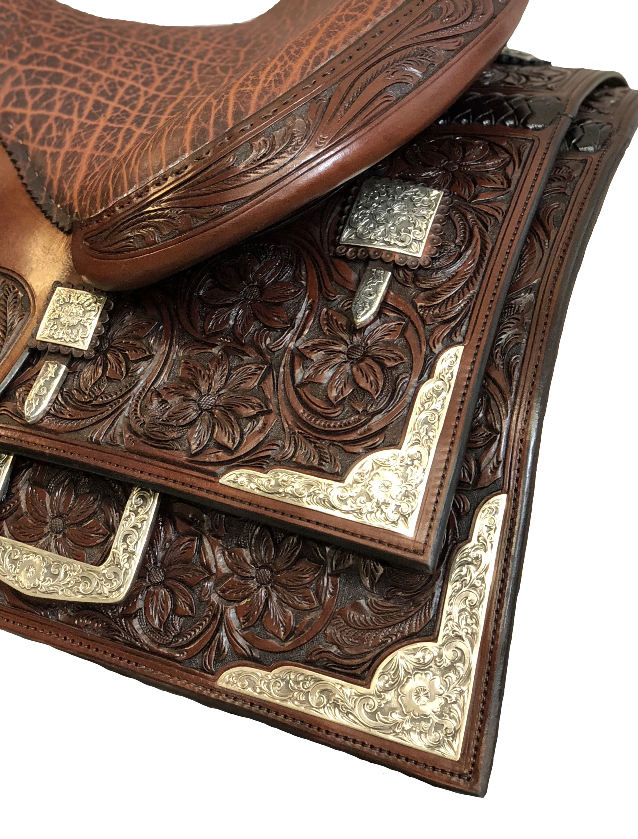 Tombstone flower scalloped skirt corners and housing plates for western saddles.